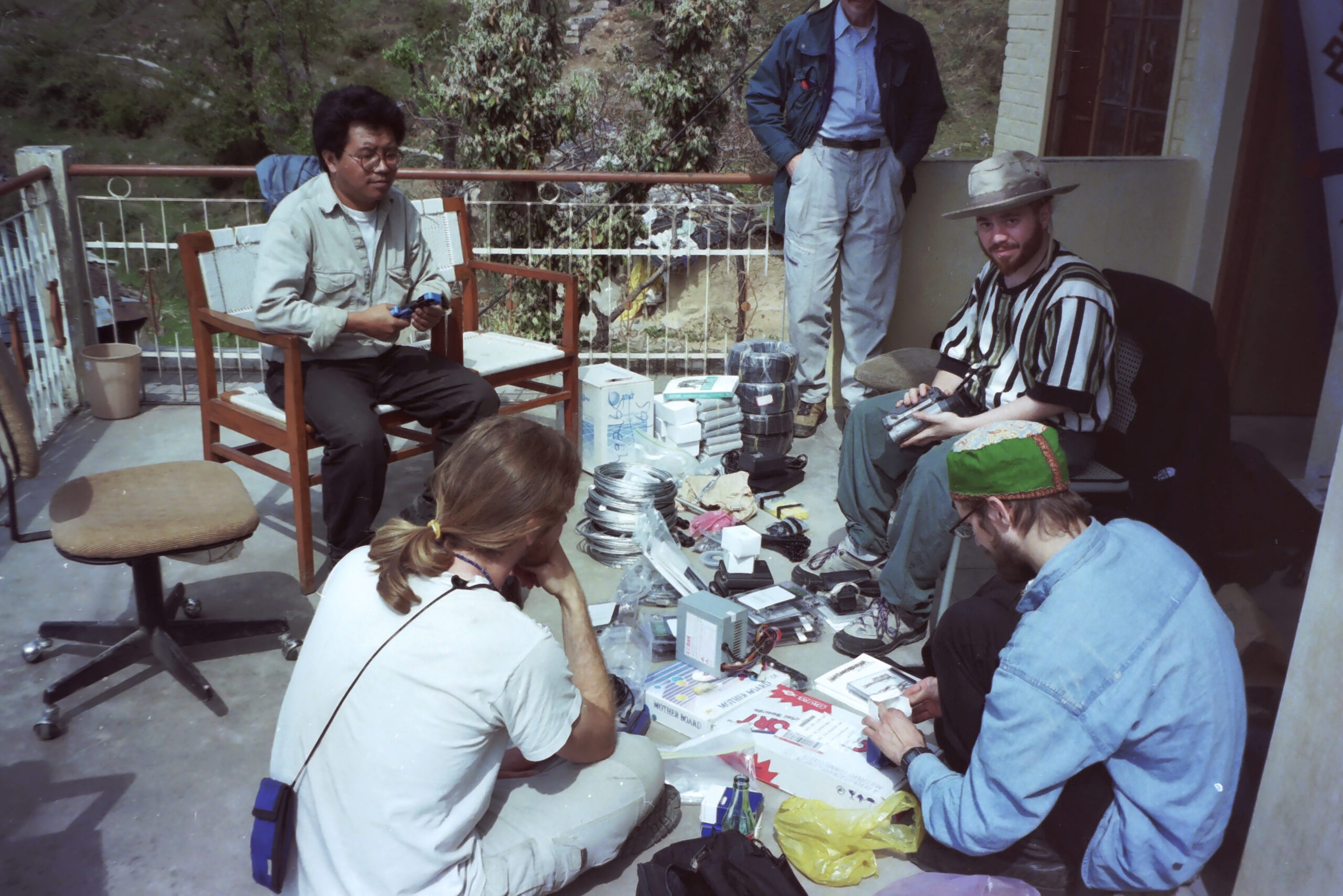 Taking inventory of network hardware on the TCRC veranda. Clockwise from upper left: Delhi TibetNet manager Sonam Dargyay, Ari Salomon, Stefan Lisowski, Dan Haig